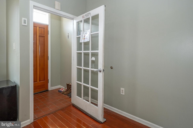 entryway with dark hardwood / wood-style flooring