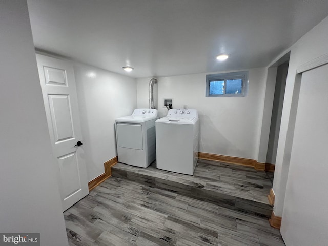 washroom with wood-type flooring and washer and clothes dryer