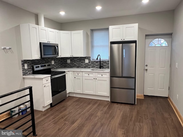 kitchen featuring sink, white cabinets, appliances with stainless steel finishes, and dark hardwood / wood-style flooring