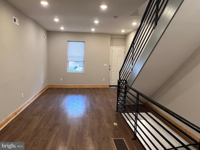 entryway with dark hardwood / wood-style flooring