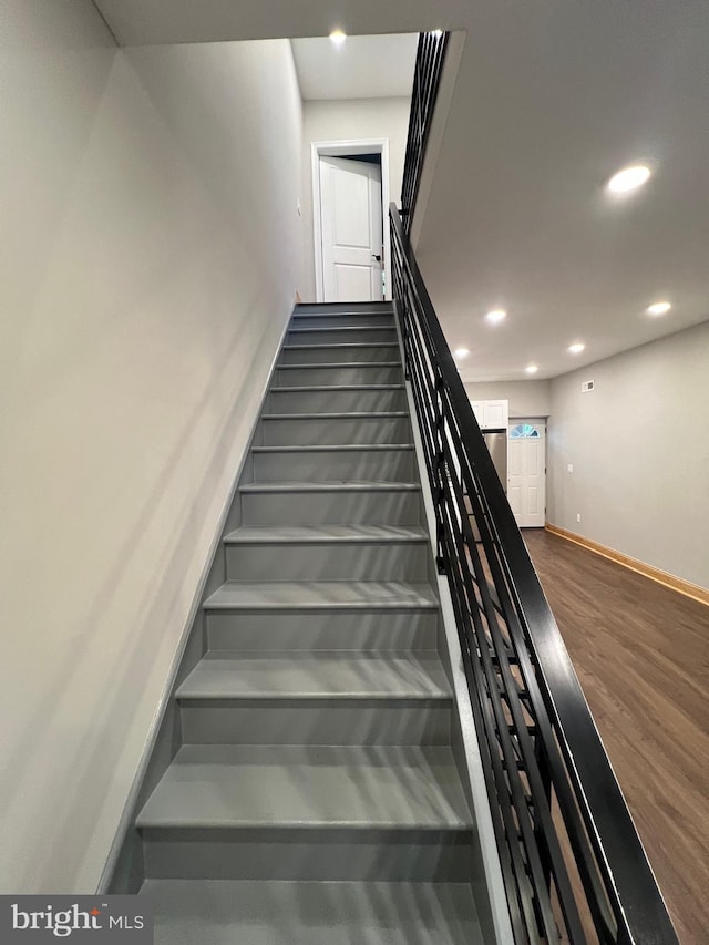 staircase featuring hardwood / wood-style flooring