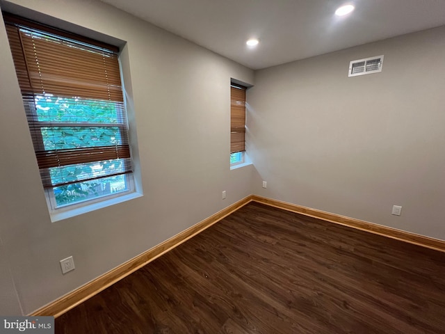 unfurnished room featuring plenty of natural light and hardwood / wood-style floors