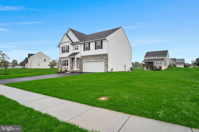 view of front of property featuring a garage and a front lawn