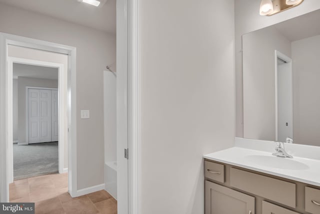 full bath featuring tile patterned flooring, vanity, shower / bath combination, and baseboards