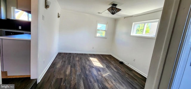 empty room with dark hardwood / wood-style flooring