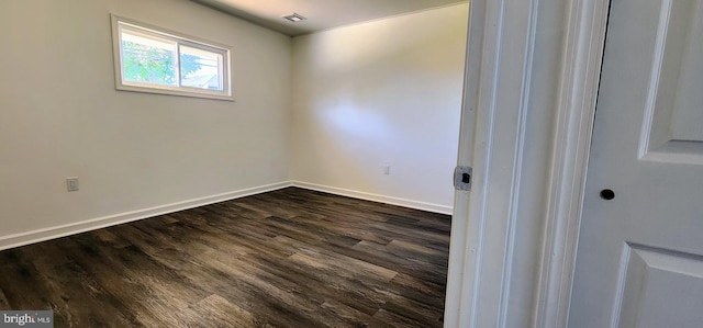 empty room featuring dark hardwood / wood-style flooring