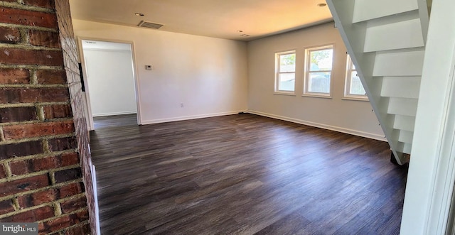 spare room with dark hardwood / wood-style floors