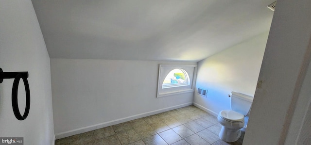 interior space featuring lofted ceiling and light tile patterned floors