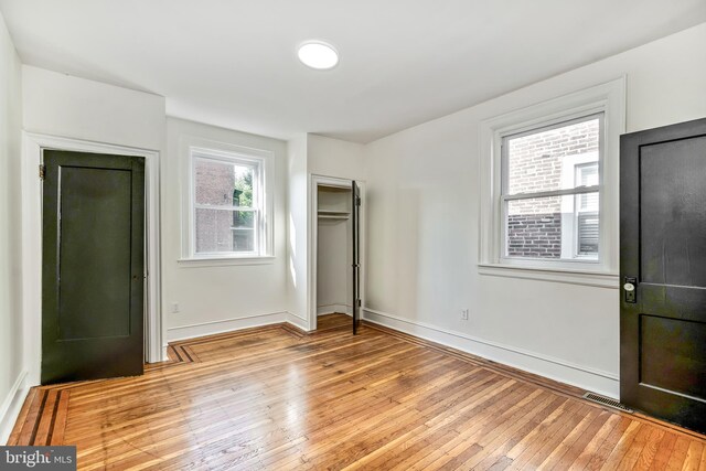 interior space featuring brick wall and wood-type flooring