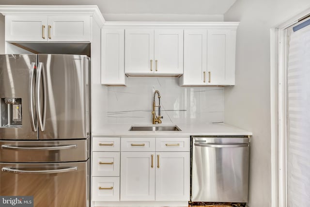 kitchen featuring stainless steel appliances, white cabinetry, and sink