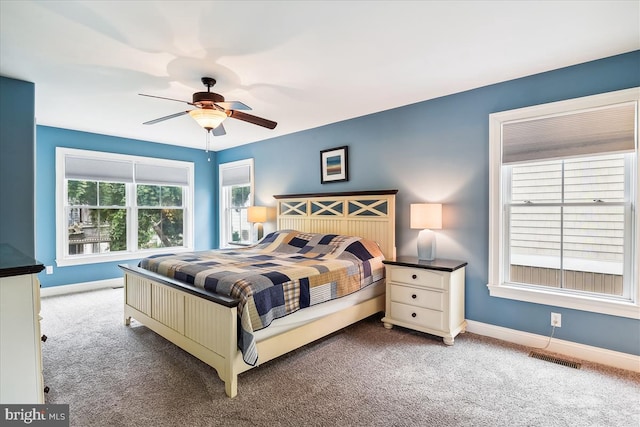 bedroom with carpet, visible vents, baseboards, and ceiling fan