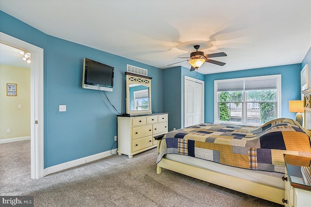 bedroom with baseboards, a closet, visible vents, and carpet flooring