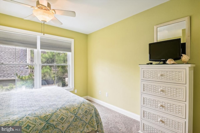 carpeted bedroom with ceiling fan and baseboards