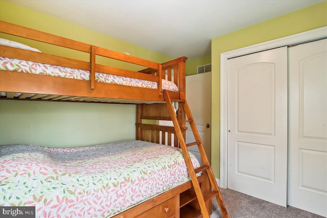 carpeted bedroom with a closet and visible vents