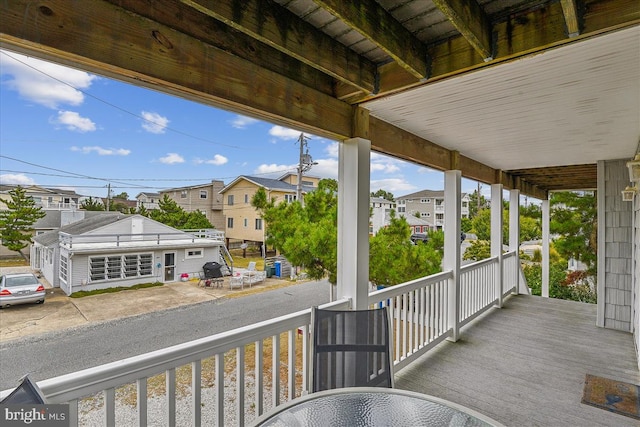 wooden terrace with a porch and a residential view