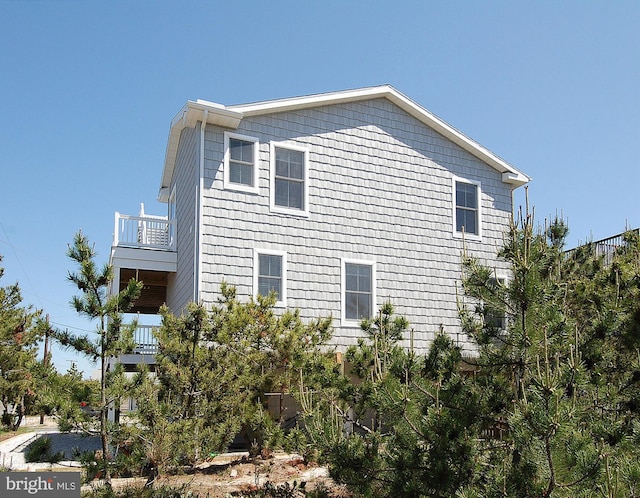 view of side of property with a balcony