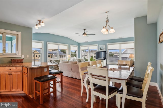 dining area with dark wood-style floors, baseboards, vaulted ceiling, and ceiling fan with notable chandelier