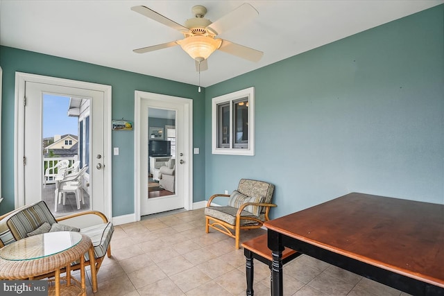 sunroom / solarium with a ceiling fan