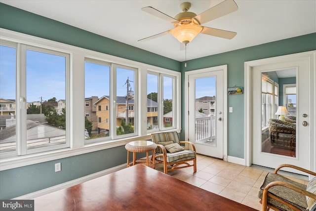 sunroom / solarium featuring a ceiling fan