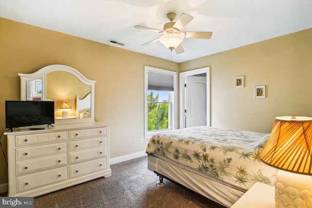 bedroom with ceiling fan, baseboards, visible vents, and dark colored carpet