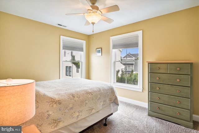 carpeted bedroom with visible vents, ceiling fan, and baseboards