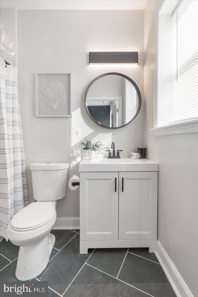 bathroom with tile patterned floors, toilet, and vanity