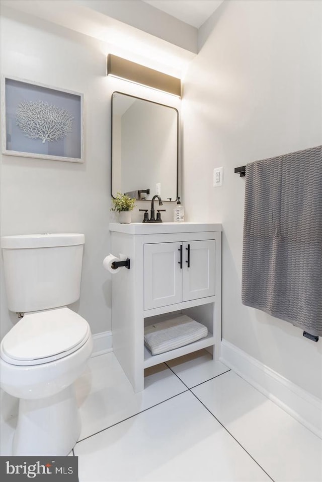 bathroom featuring vanity, toilet, and tile patterned flooring