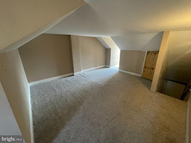 bonus room with carpet and lofted ceiling