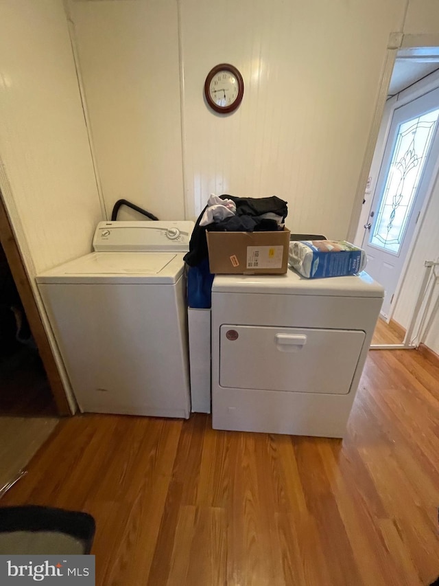 washroom featuring washer and clothes dryer and light wood-type flooring