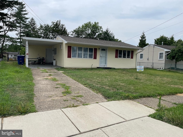 view of front facade with a front lawn and a carport