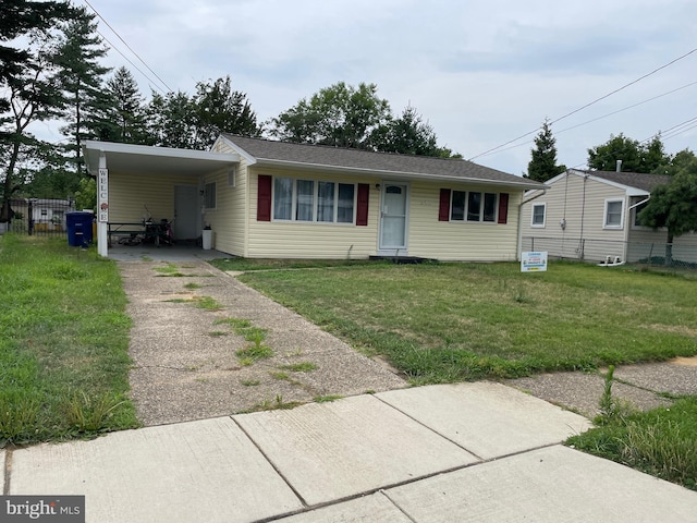 view of front facade with a carport and a front lawn