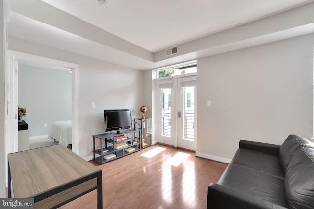 living room with hardwood / wood-style flooring and french doors