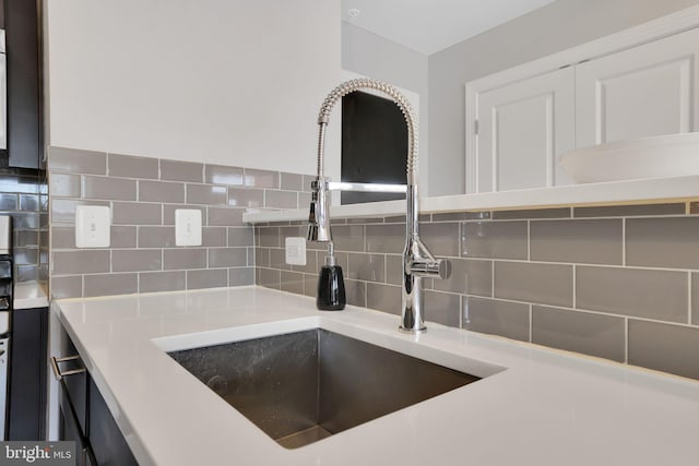 details featuring sink and backsplash