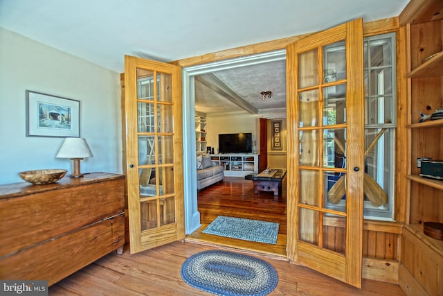 doorway to outside with french doors and wood-type flooring