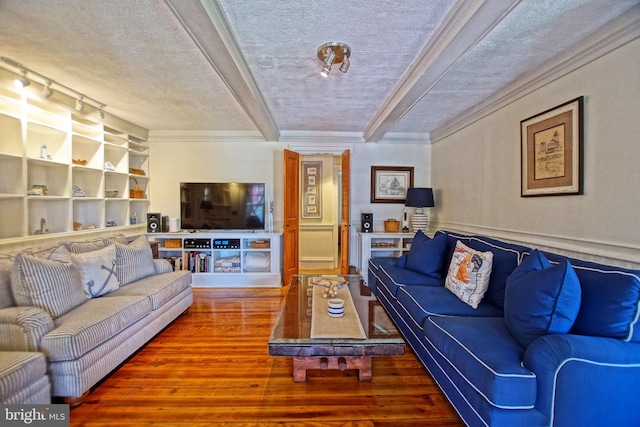 living room with hardwood / wood-style flooring, ornamental molding, and a textured ceiling