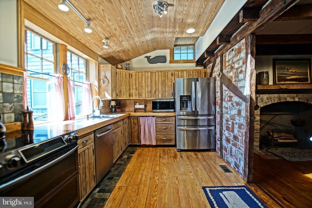 kitchen with sink, wood ceiling, light wood-type flooring, plenty of natural light, and appliances with stainless steel finishes