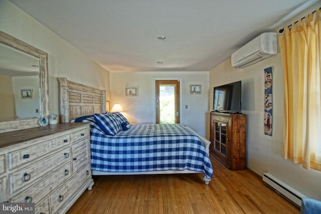 bedroom featuring hardwood / wood-style flooring, a wall mounted air conditioner, and baseboard heating