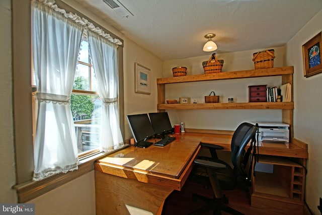 office featuring wood-type flooring and a textured ceiling