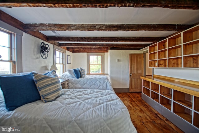 unfurnished bedroom with dark hardwood / wood-style floors and beam ceiling