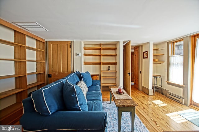 living room featuring light wood-type flooring and baseboard heating