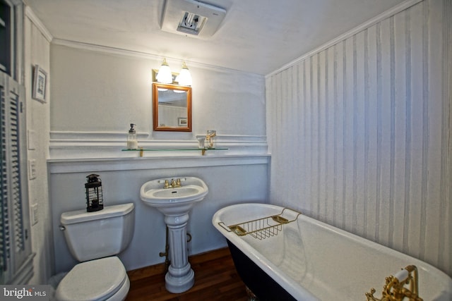 bathroom with a tub to relax in, crown molding, hardwood / wood-style floors, and toilet