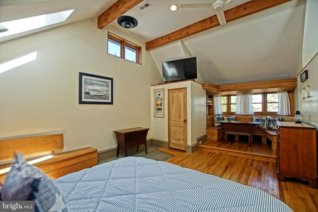 bedroom featuring hardwood / wood-style flooring, high vaulted ceiling, beam ceiling, and a skylight