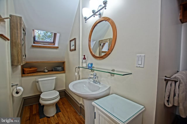 bathroom with hardwood / wood-style floors, sink, and toilet