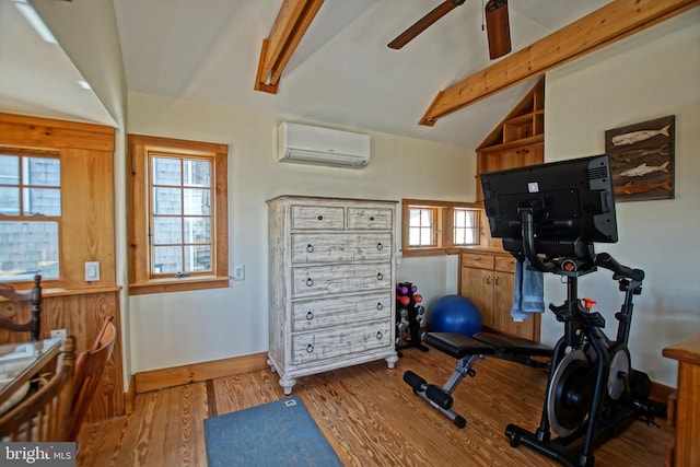 workout room featuring ceiling fan, lofted ceiling, a wall mounted air conditioner, and light hardwood / wood-style flooring