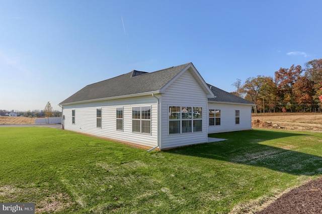 rear view of property with a lawn