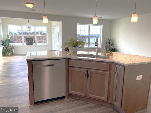 kitchen featuring decorative light fixtures, stainless steel dishwasher, plenty of natural light, and sink