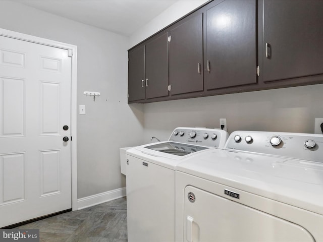 laundry area featuring cabinets and washer and clothes dryer