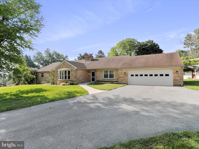 ranch-style house with a garage and a front yard