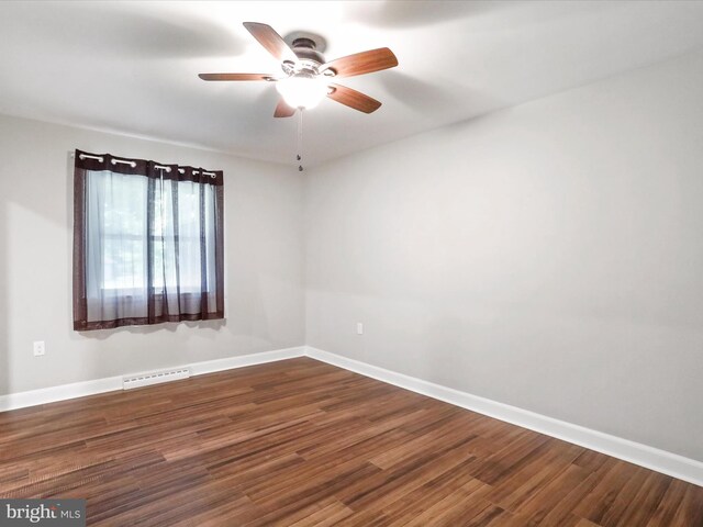 empty room featuring ceiling fan and dark hardwood / wood-style floors