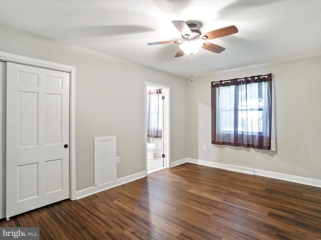 unfurnished bedroom featuring dark hardwood / wood-style floors, connected bathroom, ceiling fan, and a closet